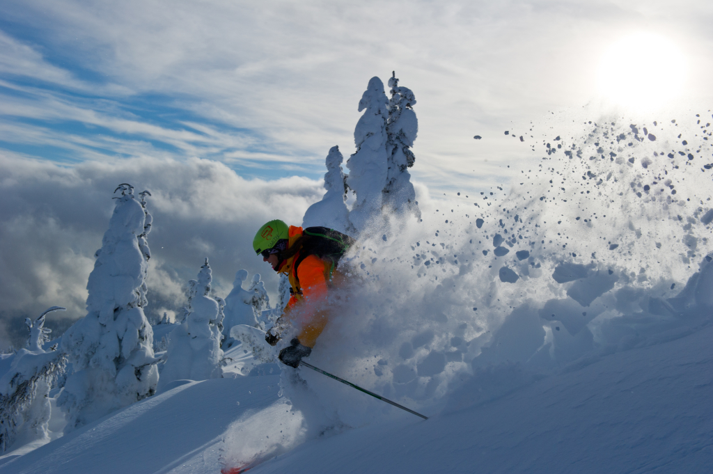 A man skiing through powdery snow - heli-skiing mistakes not to make