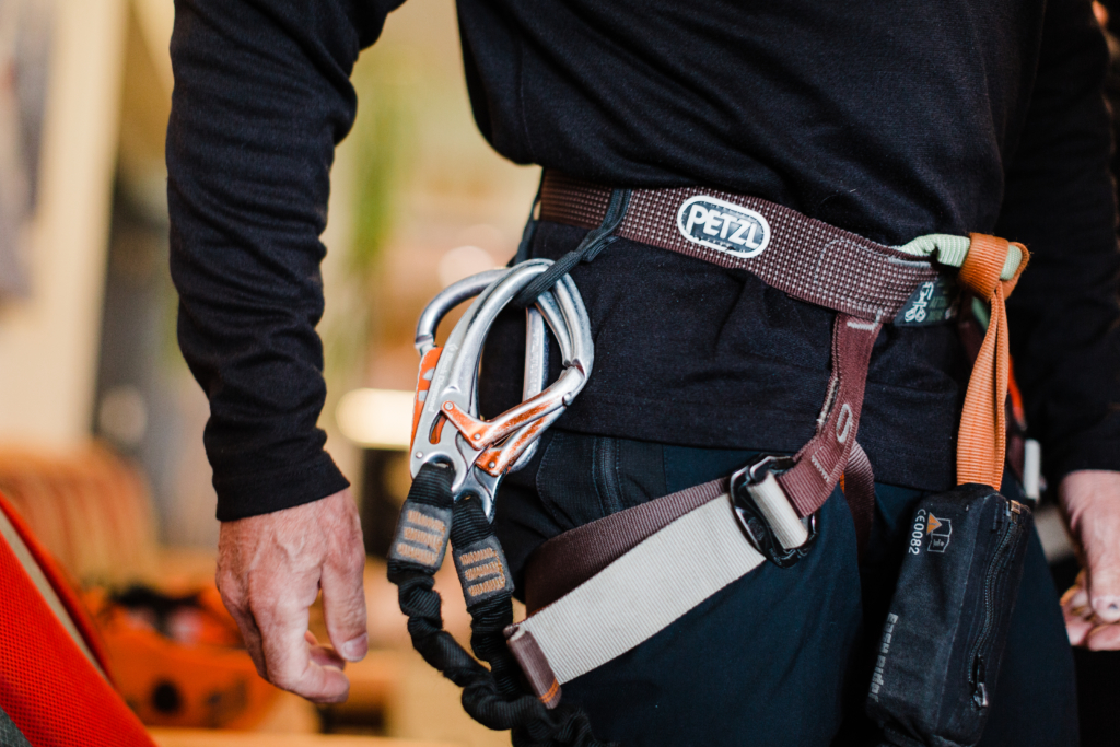 Male showing the climbing equipment used on a via ferrata.