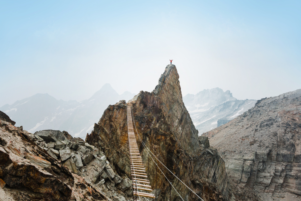 A mountain peek with a suspension bridge - heli-skiing mistakes not to make