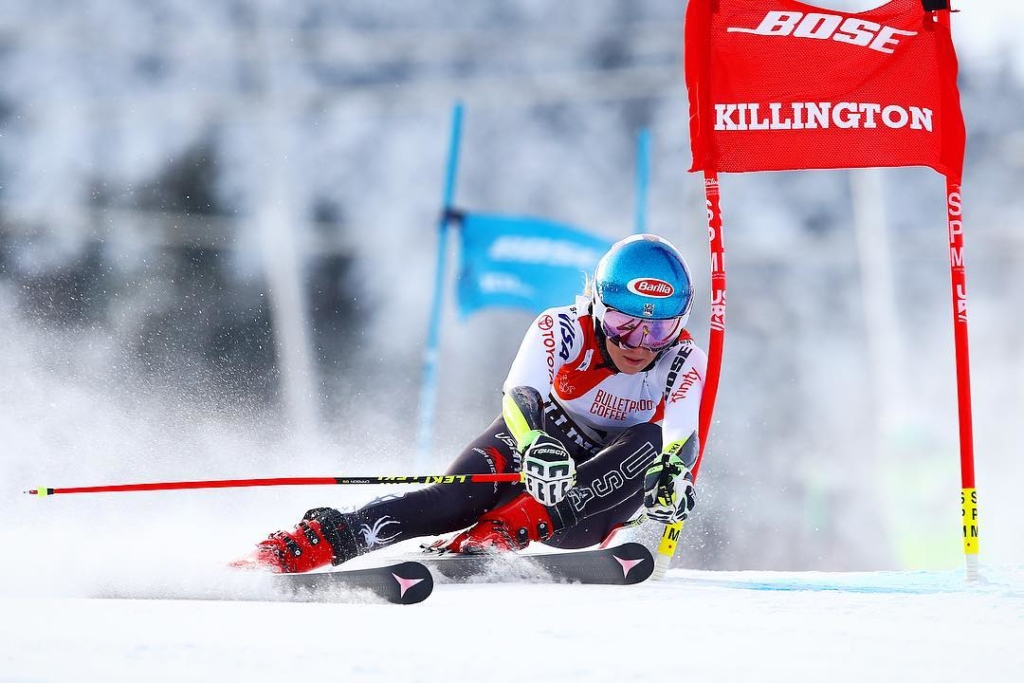 Female ski racer skies down at a fast pace