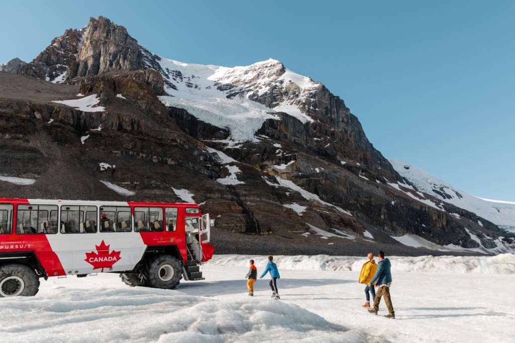 A large truck sits on a glacier on the Icefields Parkway