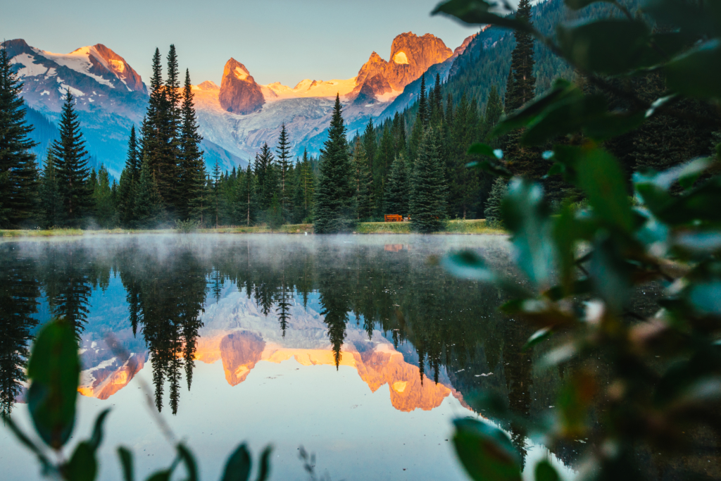 A still reflection pond sits next to CMH Bugaboo Lodge.