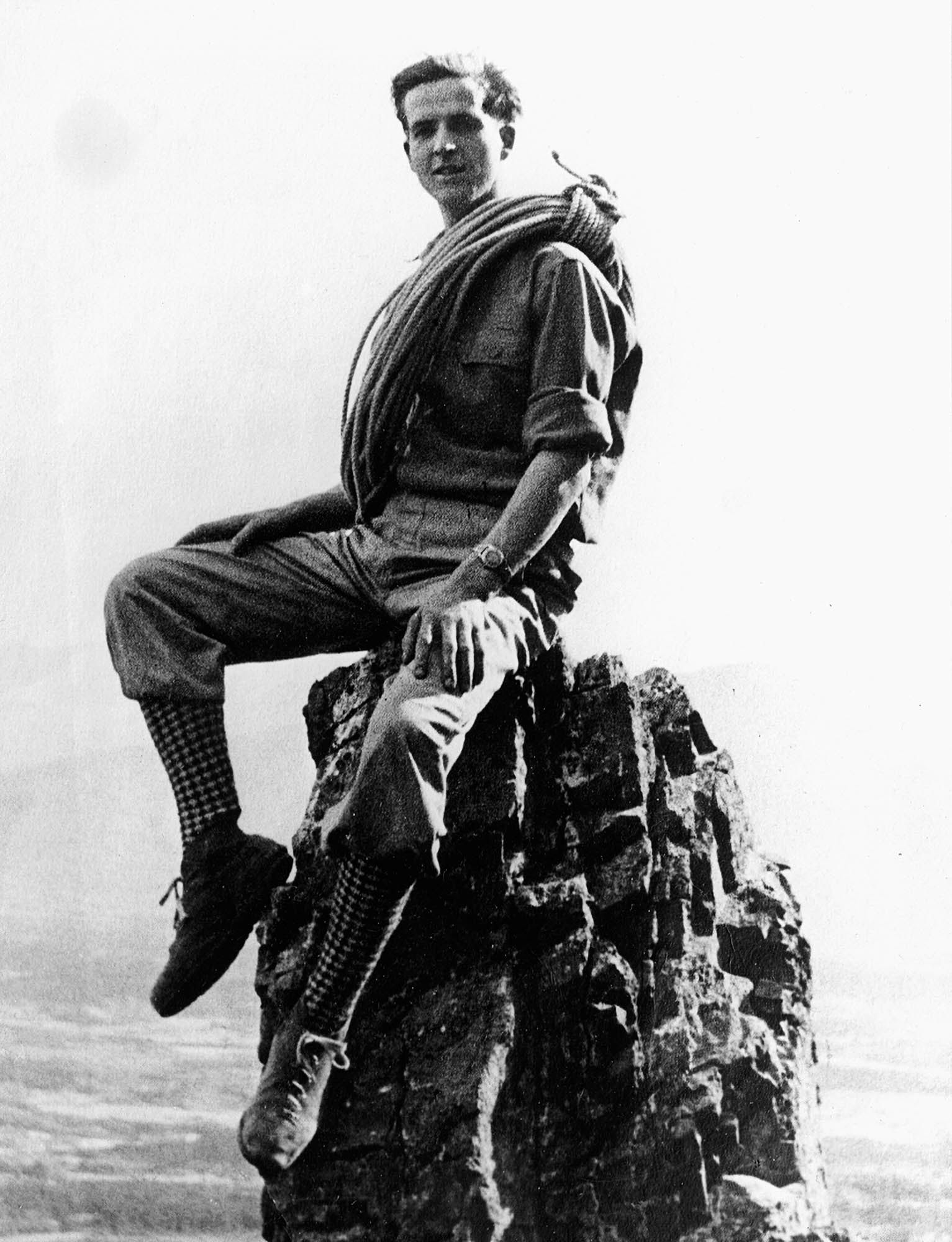Leo strikes a pose on a pinnacle of Mount Yamnuska, Alberta Rockies, circa early 1950s. Photo by Franz Dopf.