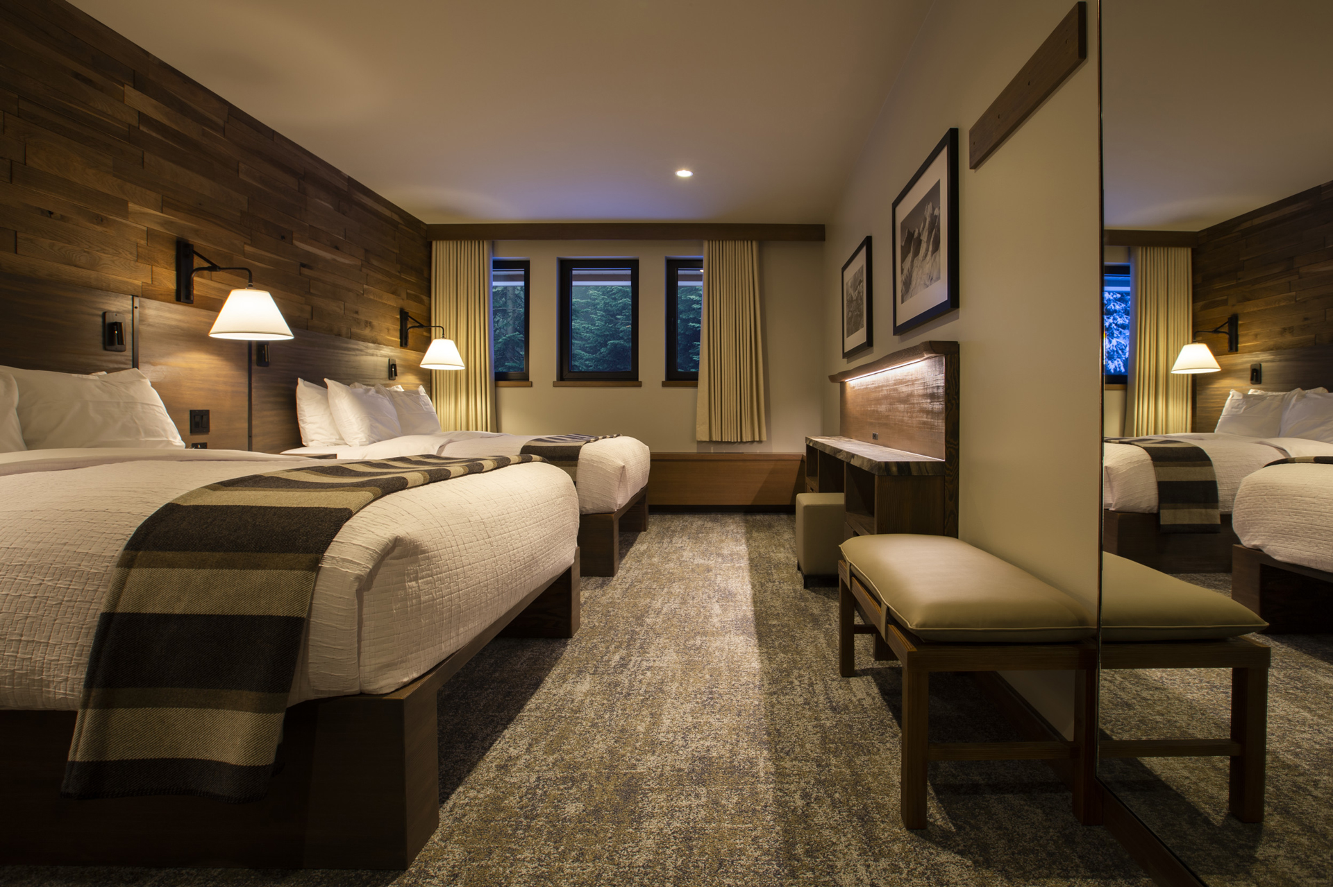 A still photo of a luxurious lodge room with two beds. 