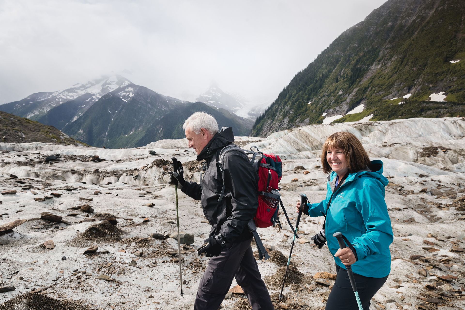 A middle aged couple hiking in the mountains. 