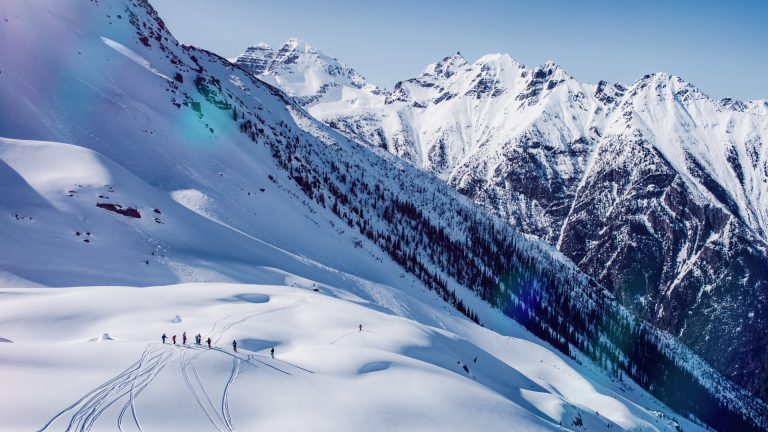 A group of skiers in a vast mountain landscape