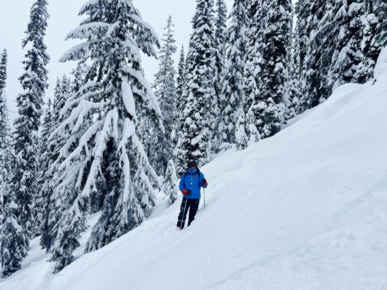 Eric Dube poses on skis mid ski run.